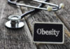 Dead Seven-Year-Old Weighed 255 – Murder? A stethoscope next to a sign that reads 'Obesity'