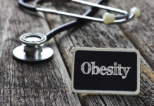 Dead Seven-Year-Old Weighed 255 – Murder? A stethoscope next to a sign that reads 'Obesity'