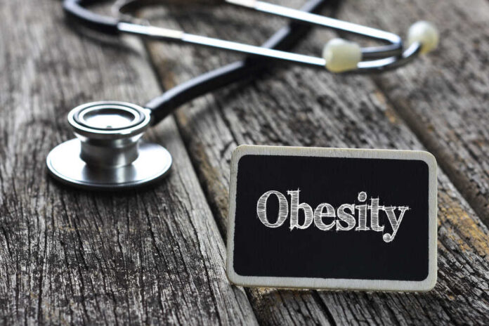Medical,Concept-obesity,Word,Written,On,Blackboard,With,Stethoscope,On,Wood A stethoscope next to a sign that reads 'Obesity'
