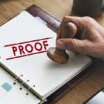GPS Bombshell Shreds Husband’s Story About Missing Wife A hand holding a wooden stamp over a document marked 'PROOF'