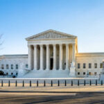 Supreme Court’s Silent Gut-Punch Hits Trump Supreme Court building with columns and U.S. flag