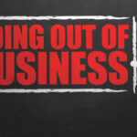Retail Bloodbath: Giant Store Chain Sinking A hand writing 'GOING OUT OF BUSINESS' on a chalkboard