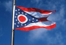 Ohio Governor Slams Trump Plan USCIS documents and a green card on a table