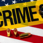 VIDEO: Police Office Killed During Mass Shooting A gun and bullets on an American flag with a crime scene marker