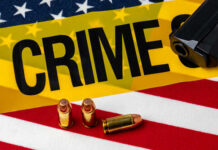 VIDEO: Police Office Killed During Mass Shooting A gun and bullets on an American flag with a crime scene marker