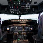 Interior view of an airplane cockpit with various instruments and controls