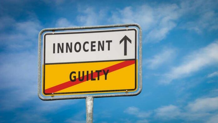 Street,Sign,The,Direction,Way,To,Innocent,Versus,Guilty A road sign displaying 'INNOCENT' with an arrow pointing up and 'GUILTY' crossed out