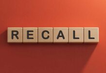 Choking Risk Lurks in Trusted Kids’ Pouch? Wooden letter tiles spelling recall on an orange background