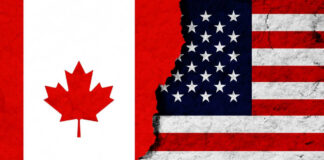 Canadian and American flags with torn dividing line