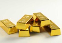 Buried Gold Rings Disrupt Historic Origin Story A stack of shiny gold bars arranged on a light background