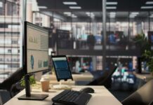 Xbox Bloodbath Sparks Bigger Mystery Computer monitor with analytics dashboard in a modern open office
