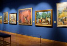 Museum Alarms Fail — Again! Art gallery showcasing various colorful paintings on a blue wall