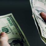 Olympic Wage Bomb — LA Blinks Hands holding and counting stacks of cash