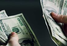 Olympic Wage Bomb — LA Blinks Hands holding and counting stacks of cash