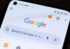 Close-up of a smartphone displaying the Google search interface