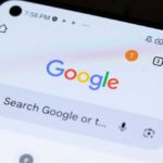 Close-up of a smartphone displaying the Google search interface