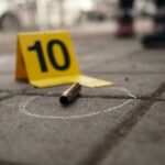 8 Shot As Masked Gunman Terrorizes Boardwalk Bullet casing on the ground next to a numbered evidence marker