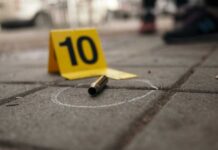 8 Shot As Masked Gunman Terrorizes Boardwalk Bullet casing on the ground next to a numbered evidence marker