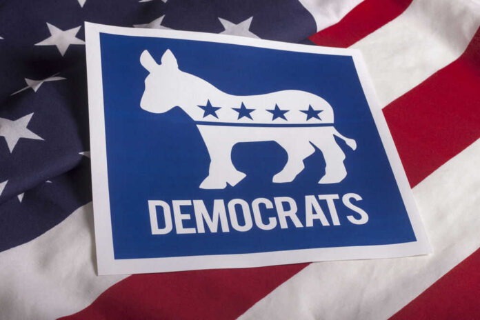 shutterstock_3058522132 Democrats logo on American flag background.