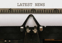 Close-up of a typewriter with a sheet of paper displaying the words 'LATEST NEWS'