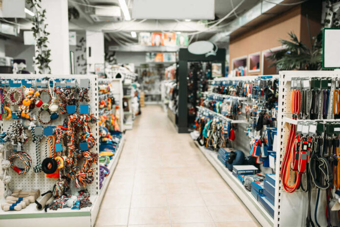 Pet,Shop,Interior,,Shelves,With,Accessories Pet store aisle with shelves of dog toys, leashes, and collars