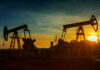Gas Pain, Record Profits — Trump Explodes Oil pumpjacks silhouetted at sunset on a rural field