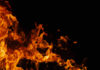 Arson Suspect With Killing Past Sparks Inferno? Firefighter spraying water on burning forest trees at night