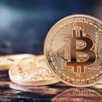 Bitcoin Whiplash Hammers Trump Media Bitcoin coins on a reflective surface.