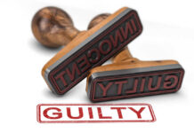 CEO Killing: Shocking Guilty Twist Two rubber stamps labeled guilty and innocent on a white surface