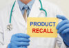 Metal In Dinner? Massive Recall Follows Doctor holding a product recall sign in gloves