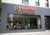 Chipotle Outbreak Lawsuit Explodes Chipotle Mexican Grill restaurant exterior with people inside.