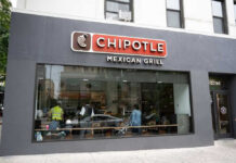 Chipotle Outbreak Lawsuit Explodes Chipotle Mexican Grill restaurant exterior with people inside.