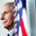 Fauci Pardon Gamble Explodes Anthony Fauci close-up with flag.