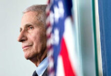 Fauci Pardon Gamble Explodes Anthony Fauci close-up with flag.