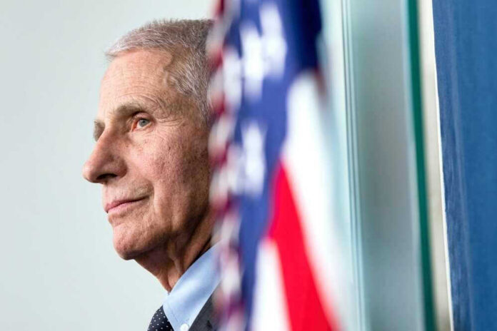 shutterstock_2465460457 Anthony Fauci close-up with flag.