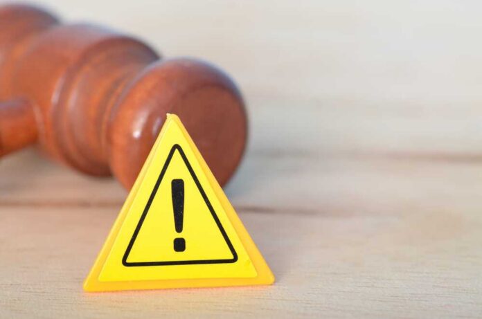 Warning,Sign,And,Judge,Gavel:,Symbols,Of,Legal,Authority,And Yellow warning triangle with exclamation mark beside a wooden gavel