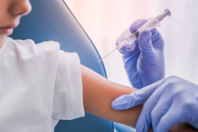 Close,Up,Of,Doctor,Injecting,Vaccine,In,Boy's,Arm,In A healthcare professional administering a vaccine to a child's arm