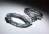 Horror Mask Menace Nabbed Close-up of metallic handcuffs on a light surface