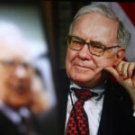 Warren Buffett seated in a suit, resting his hand on his cheek