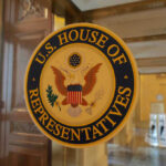 Demolition Threat Rattles Kennedy Center U.S. House of Representatives seal on glass door.