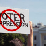 Judge Greenlights Trump’s Voting Plan Person holding No Voter Suppression sign outside White House.