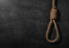 BOMBSHELL: Detective Says She Died Before the Hanging A noose made of rope hanging against a dark textured background