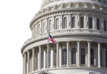Congress Bristling As THESE Costs Explode U.S. Capitol dome with American flag flying.