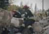Rescue workers search rubble at a disaster site