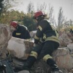 Rescue workers search rubble at a disaster site
