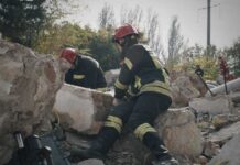 Rescue workers search rubble at a disaster site