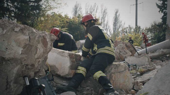 Rescue workers search rubble at a disaster site