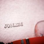 Famed Carmaker Axes Thousands Close-up of a typewriter with the word 'JOBLESS' typed on paper