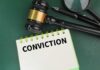 CRIME: American Idol Star Convicted A gavel resting on a notepad with the word 'CONVICTION' written on it
