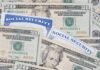Social Security Checks To Get Boosted?! A collection of twenty-dollar bills and social security cards